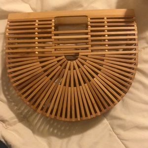 Beautiful so in style bamboo half moon clutch
